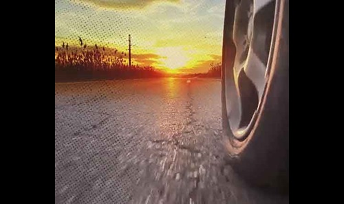 Car on the road with sunset in the background